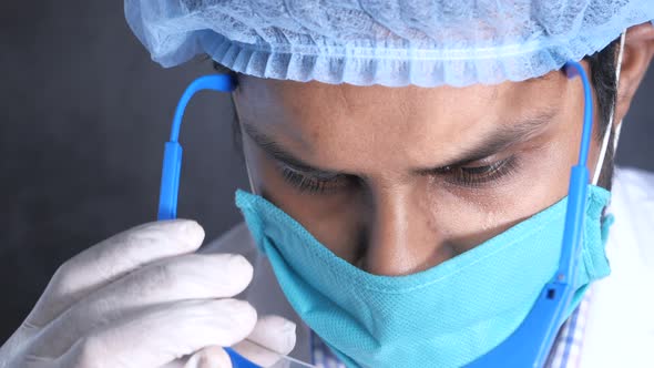 Laboratory Technician Wearing Protective Eyeglass Close Up 