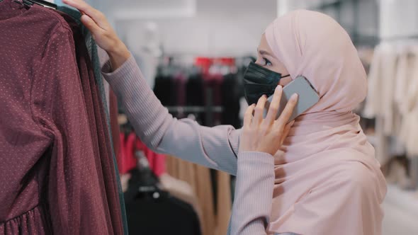 Islamic Woman Shopper in Protective Medical Mask in Clothing Store Shopping During Quarantine Muslim