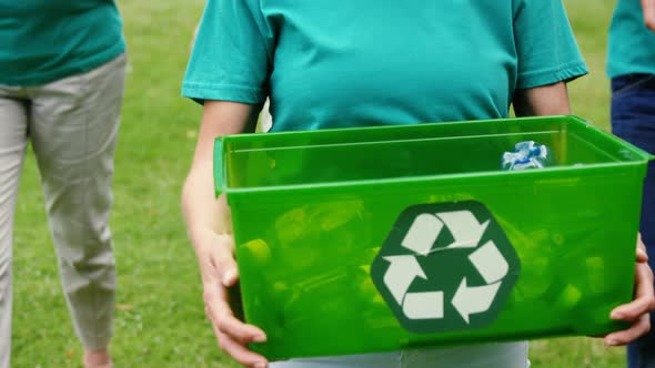 Family collecting litter in park