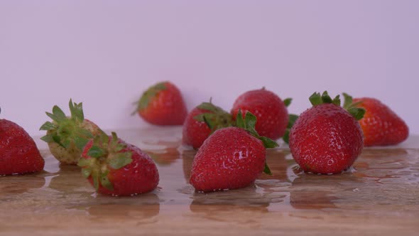 Strawberries Being Dropped While Rotating Over White Background