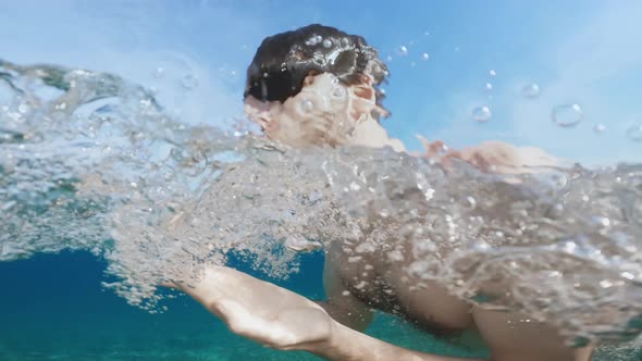 Boy Swimming Breaststroke Style in the Open Sea