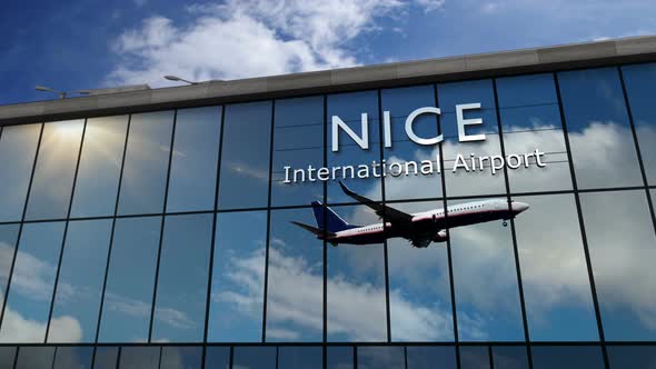 Airplane landing at Nice France airport mirrored in terminal
