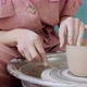 Female Potter Sitting and Makes a Cup on the Pottery Wheel. Woman Making Ceramic Item. Pottery - VideoHive Item for Sale