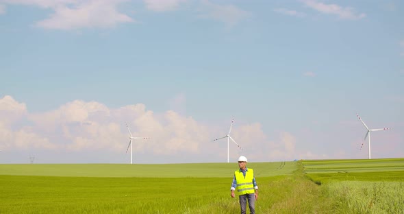 Engineer Walking on Windmill Farm