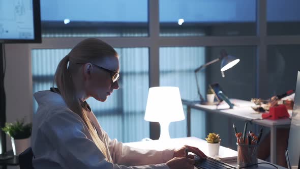 Side View of Professional Electronics Specialist Working on the Computer in Modern Laboratory