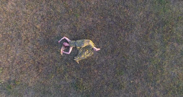 Blonde woman lying in grass and enjoying