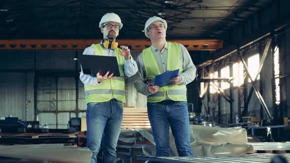 Metalware Factory Unit with Male Technicians Inspecting It