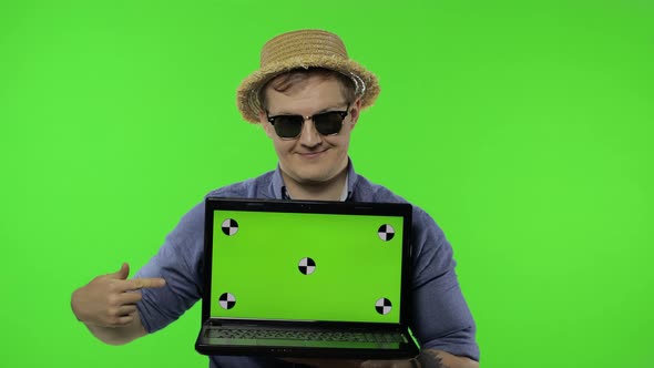 Portrait of Man Tourist in Sunglasses Showing Laptop. Thumbs Up. Chroma Key