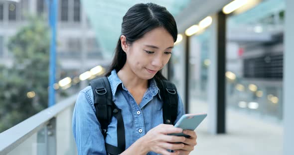 Young Student Working on Smart Phone in The City 