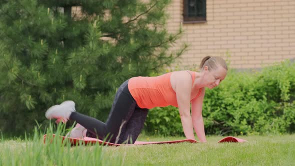 woman goes in for sports outdoors on lawn.