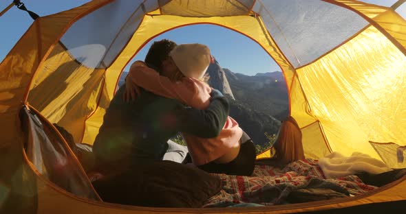 Lovers Cuddle in a Tent at the Background of the Symbol of Yosemite National Park,the Half Dome Rock