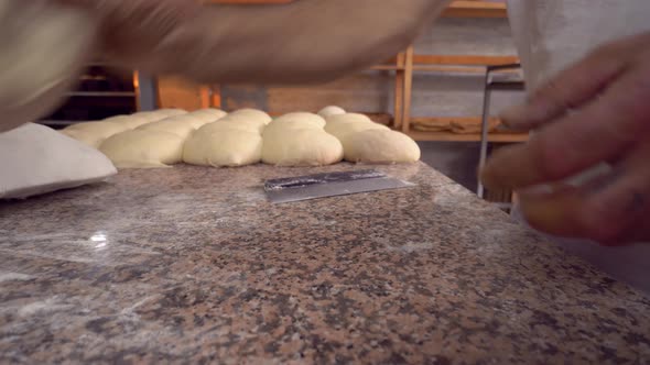 Men's hands hold dough. making raw dough for pizza, rolls or bread.