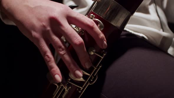 Closeup of Fingers Female Musician Playing Jazz on Bassoon at Studio