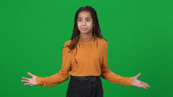 Shocked African American Girl Gesturing Holding Head in Hands Looking Around on Green Screen