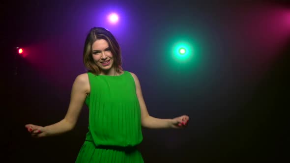 Close-up Dancing of Young Woman in Green Dress. Slow Motion