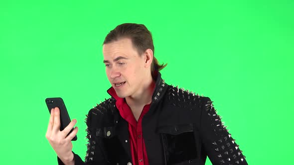 Guy Girl Angrily Talking for Video Chat Using Mobile Phone . Green Screen