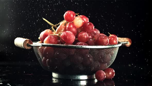 Drops of Water Fall on the Grapes in the Colander