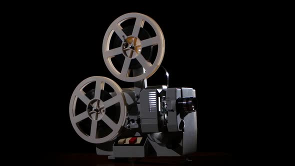 Old Projector Showing Film. Studio Black Background