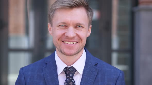 Smiling Businessman Outside Office Building