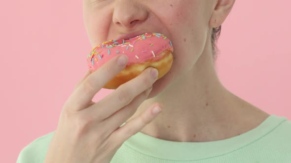 Woman Eating a Donut Closeup Delicious