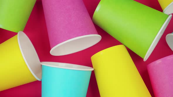 Flat Lay Multicolored Paper Cups. Background Red Color