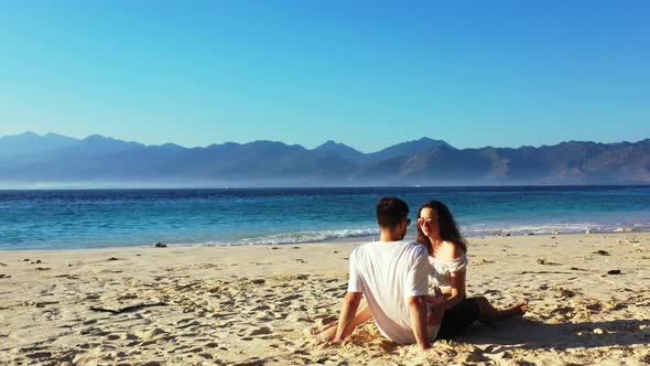 Happy people in love dating on vacation have fun on beach on clean white sand 4K background