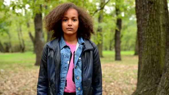 Young African Girl Stand in the Forest and Stare in To the Camera - Eye Contact