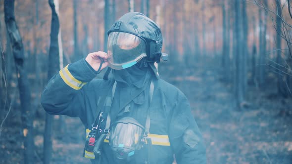 Male Firefighter Lifts Visor of His Helmet and Looking Around