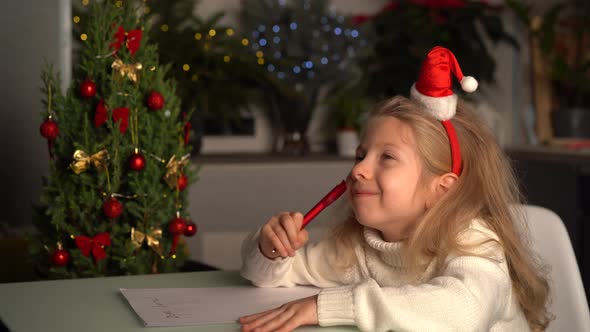 a Little Blonde Girl Writes a Letter to Santa Claus Gifts for Christmas a Happy Child