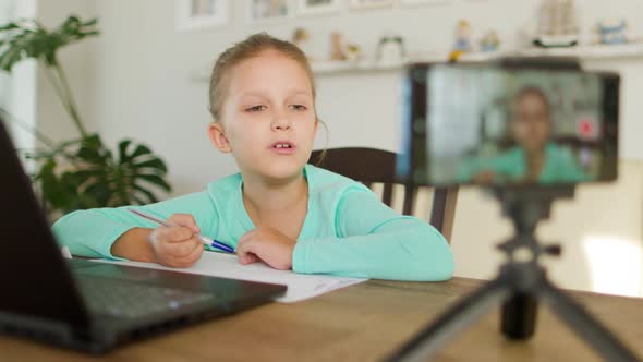 Schoolgirl Girl Doing Homework On Distance Learning