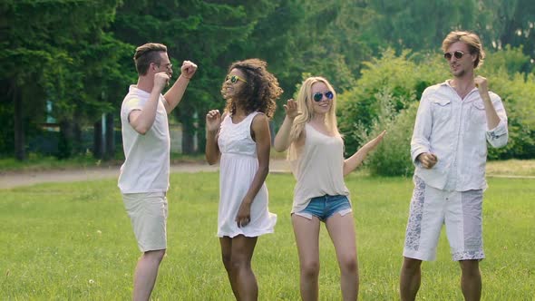 Four Young Active Friends Enjoying Summer Dancing Together, Extra-Slow Motion