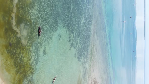 Vertical Video Boats in the Ocean Near the Coast of Zanzibar Tanzania Aerial View