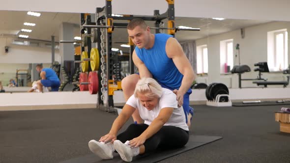 Elderly Woman is Engaged in a Sport in the Gym