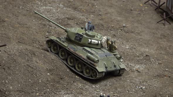 An Exhibition of Army Car Models. A Tank with Soldiers on It Drives Up the Hill.