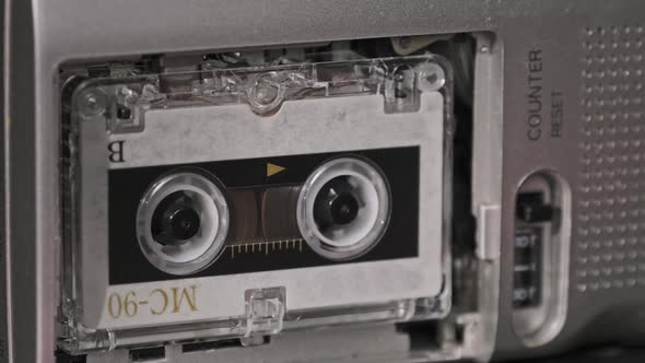 Audio Cassette in the Tape Recorder Playing and Rotates