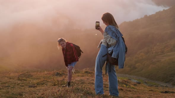 Female Teenagers Tourists are Photographing By Mobile Camera on Slope of Hill