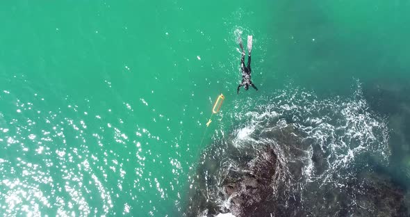 Aerial top down view of scuba diver with safety buoy