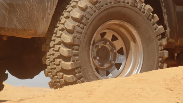 Macro Wheels of Suv That Starts Moving on Sandy Road