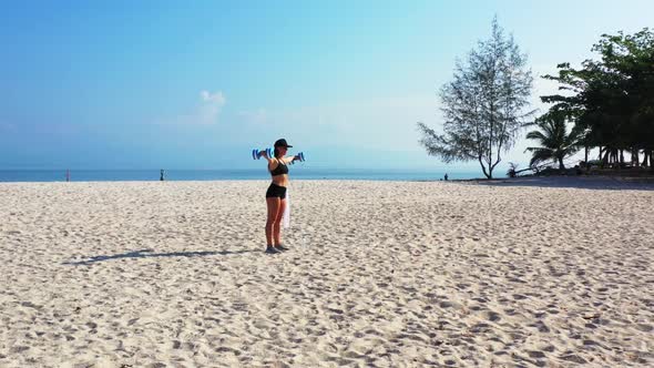 Female models look beautiful on exotic sea view beach trip by aqua blue ocean with white sand backgr