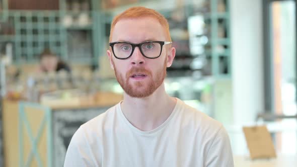 Portrait of Excited Redhead Man Celebrating Success