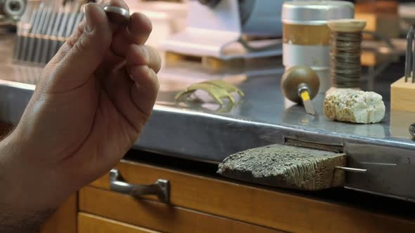 Goldsmith hands polishing a ring