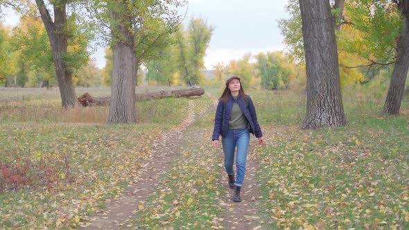 Girl Tourist on a Hike in the Autumn Forest