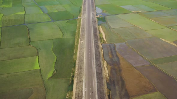 Aerial view of a road among the fields in Sapahar, Rajshahi, Bangladesh.