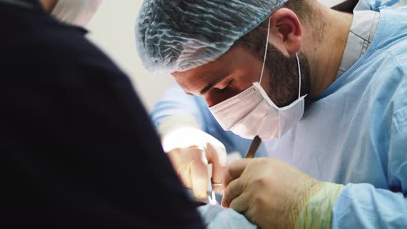 a man surgeon performs face and hands surgery close-up