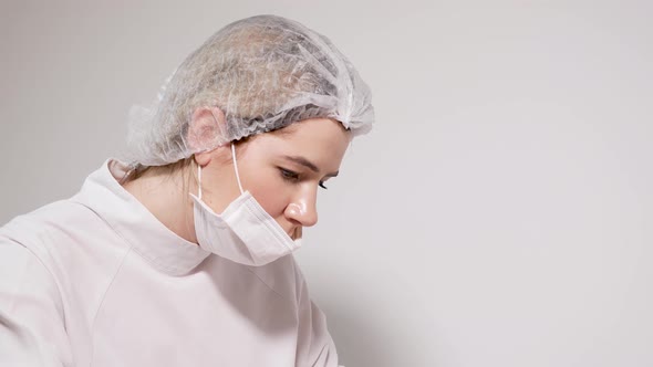 Doctor Beautician Pricks the Patient's Face