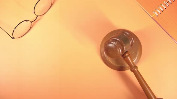 Top View of Person's Hand Striking the Gavel.