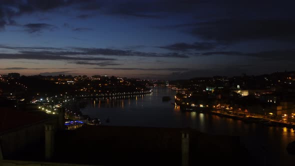 Static shot of a late evening overlooking the city lights of Porto Portugal and the Douro river