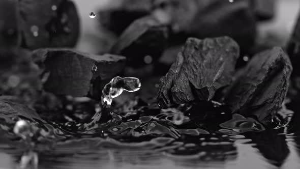 Super Slow Motion Shot of Coal Falling Into Water at 1000 Fps.