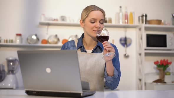 Beautiful Woman Drinking Wine and Searching Food Recipes for Romantic Dinner