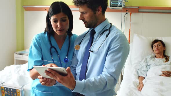 Doctors discussing on digital tablet